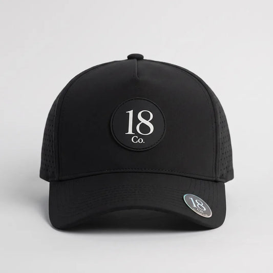 18 Co. Performance Golf Hat in black, front view, with magnetic ball marker on the brim