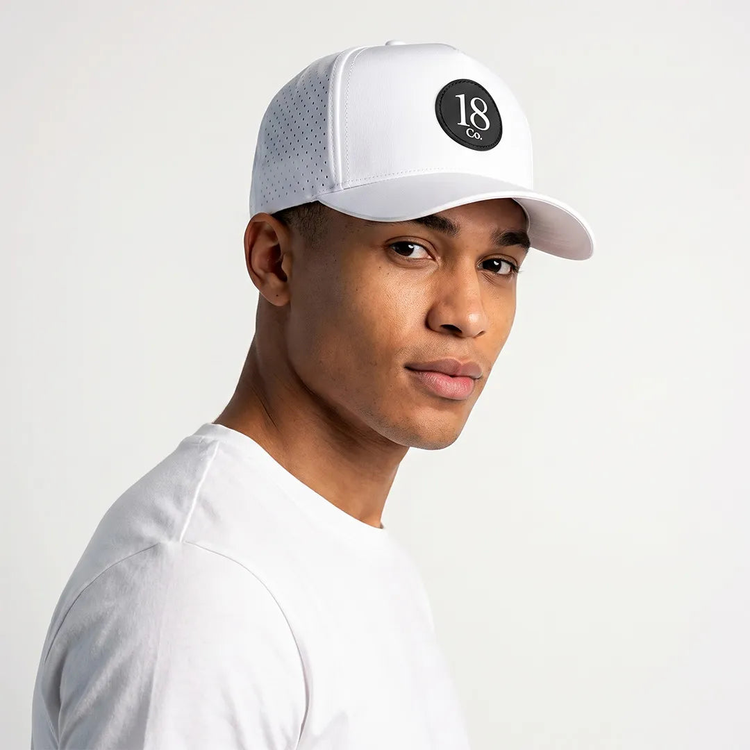18 Co. Performance Golf Hat in white with built-in magnetic ball marker